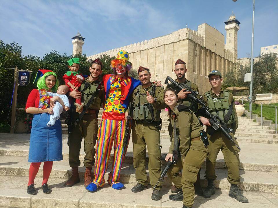 Soldiers and Residents pose with Purim clown