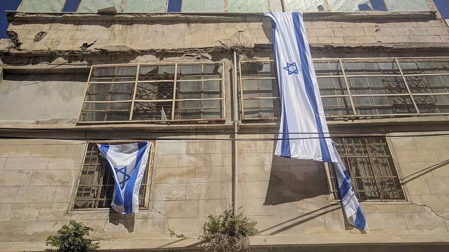 Israeli flags drape Bait Leah amidst residents' recent move back