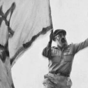 Rabbi Goren holding the Israeli flag as he liberated Hebron in June of 1967