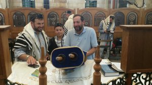 Bar mitzvah boy reads torah scroll in Ma'arat HaMachpela