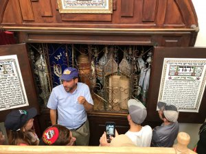 Rav Simchaa Hochbaum tells the history of the ancient torah scrolls in the Avraham Avinu shul in Hebron