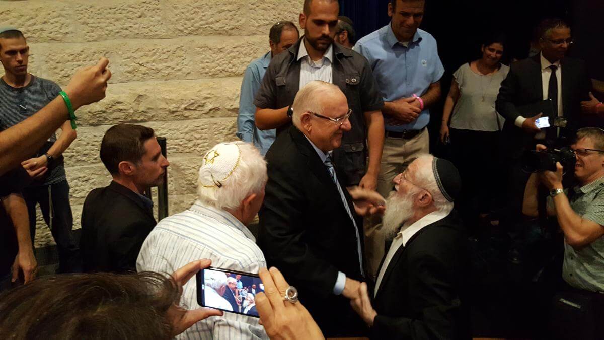  President Reuven Rivlin shakes hands with Hebron pioneer Rabbi Eliezer Waldman, as Yossi Kruchik looks on